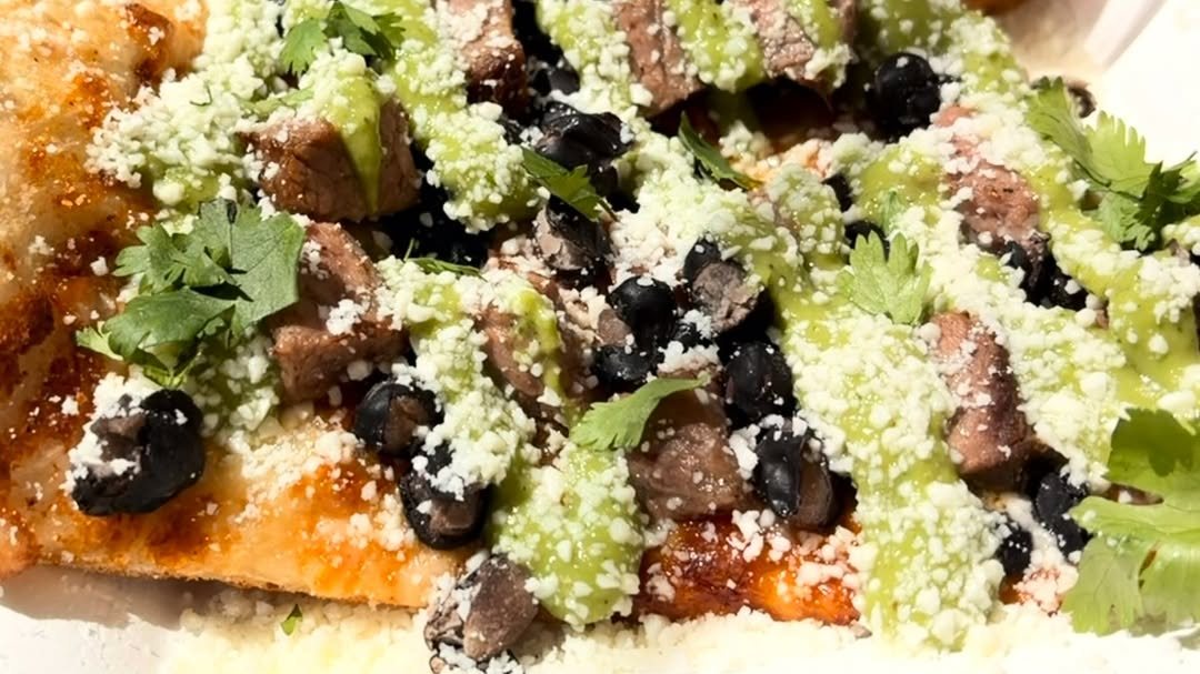 El Guapo sourdough slice topped with tri-tip, frijoles negros and avo salsa