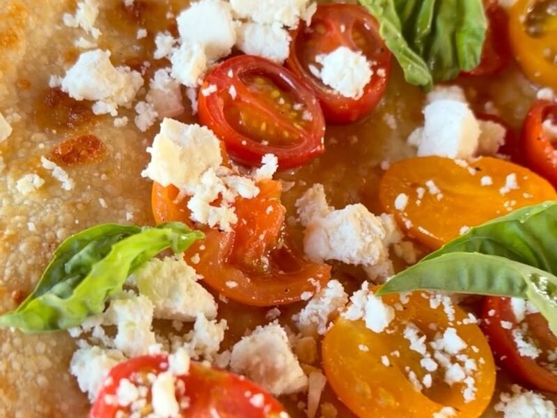 Zozula sourdough slice with red and yellow cherry tomatoes, ricotta salata and basil